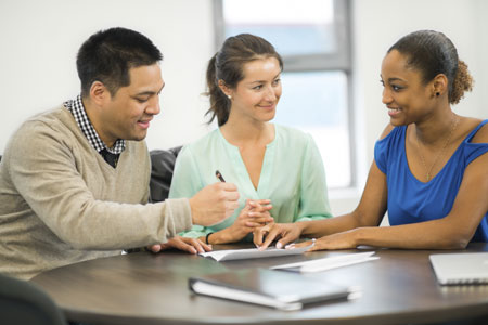 A couple signing documents in front of a notary public